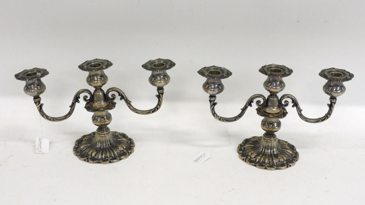 Pair of Francis I silver candelabras by Reed & Barton. Mid-20th century. Ornate embossed fruit design. Weighted base. 8" x 13".