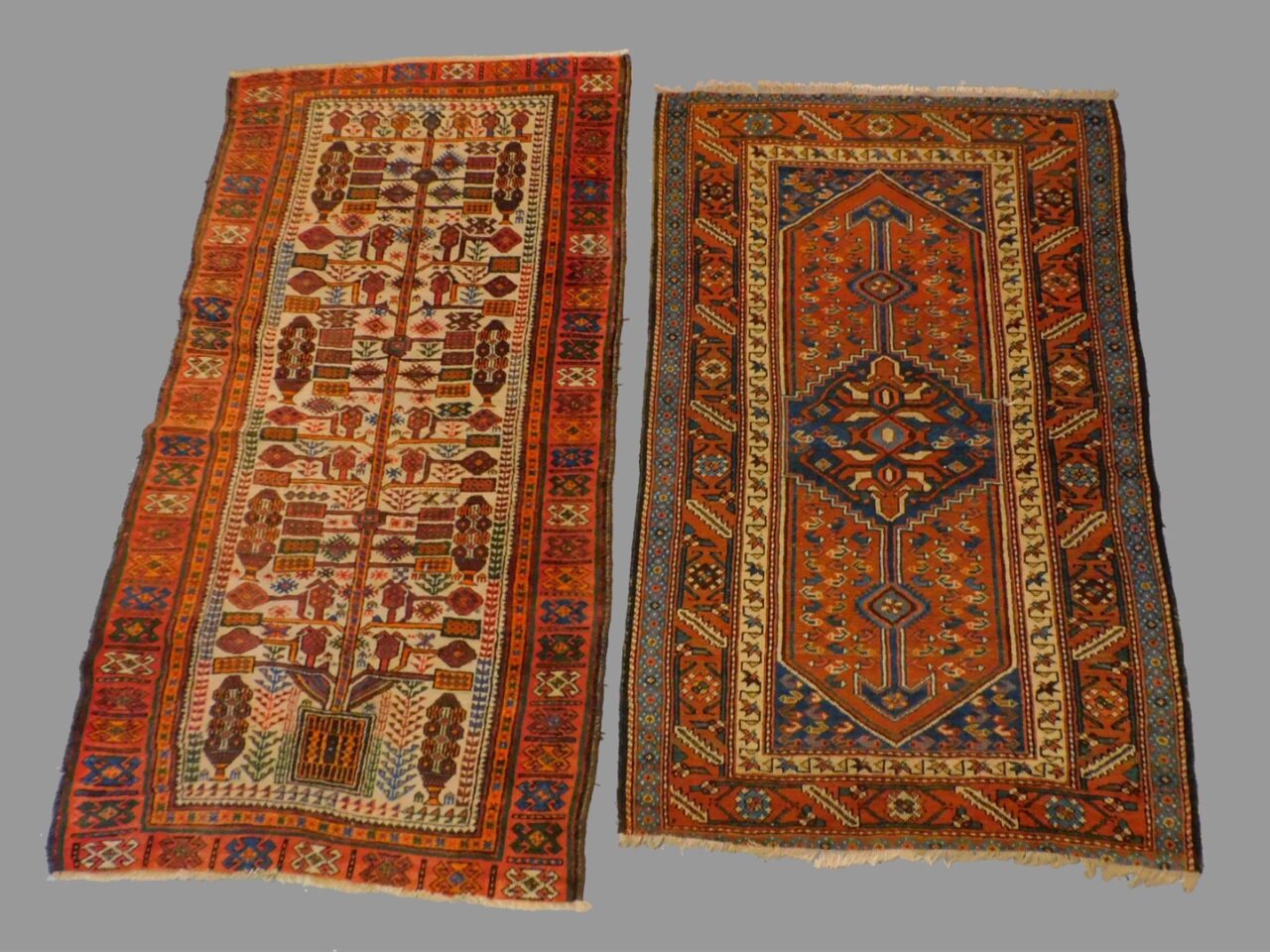 Two Antique Oriental Rugs by Unknown Artist. Early 20th century. Cream field with tree design and geometric centerfield design.