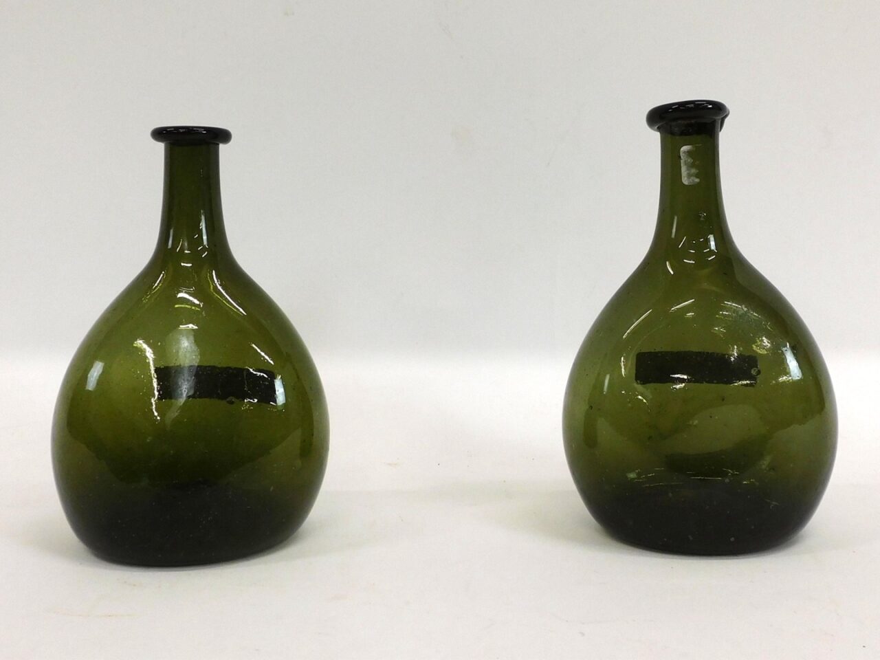 Early blown chestnut glass bottles by unknown artist