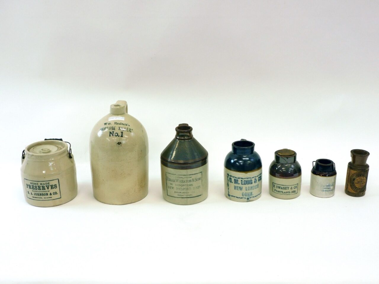 (7) Stoneware Advertising Jugs And Jars