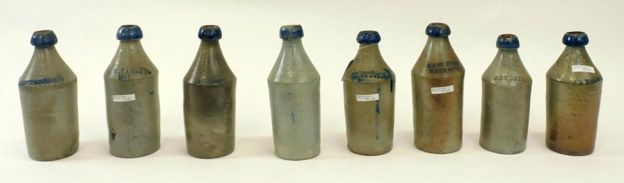 (8) Stoneware Bottles with Cobalt Enhancement.