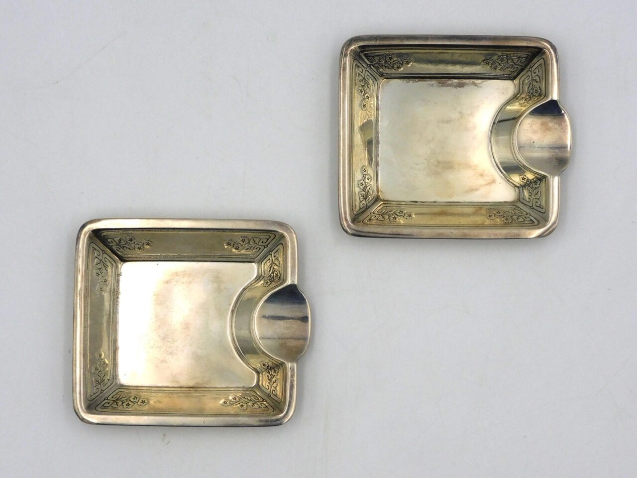 Tiffany Sterling Silver Ashtrays by Louis Comfort Tiffany. Circa 1920. Engraved floral borders. 3 1/4" x 3 3/4".