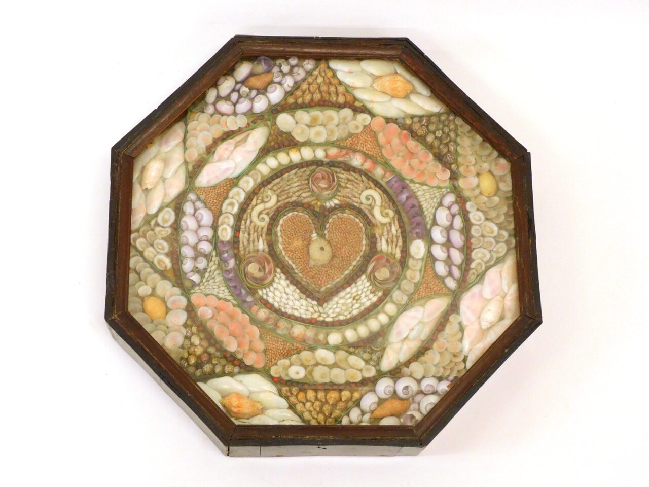 Elaborate Sailor's Valentine by Unknown Artist. 19th c. West Indies shellwork with heart motif in octagonal case.