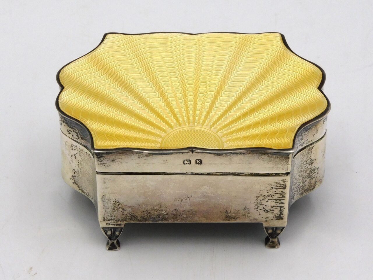 English Sterling And Guilloche Silver Box by Birmingham. Early 20th c. Shaped top with cloth interior. 1 3/4" x 3 3/4" x 2 3/4".